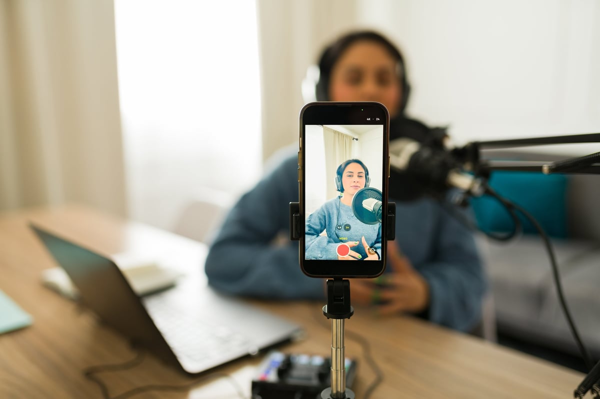 Person recording podcast with smartphone